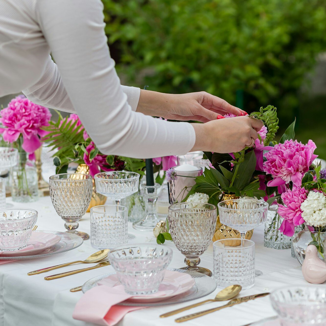 A decorator woman decorates a festive table for the celebration.